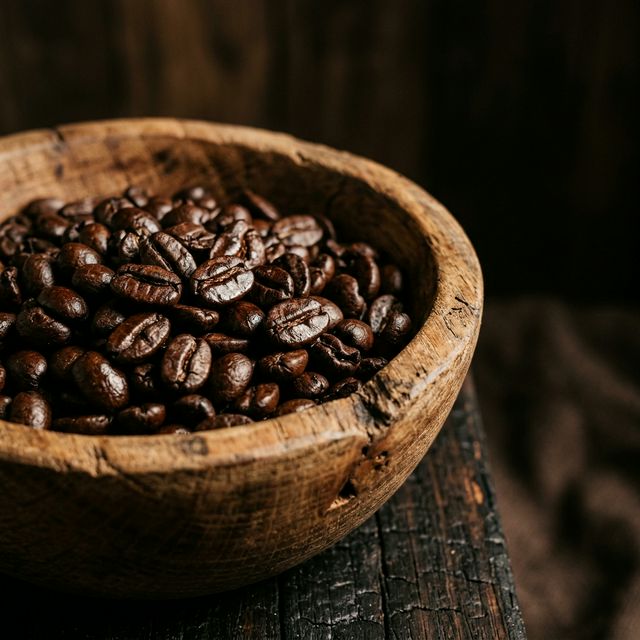 Roasted coffee beans in a wooden bowl